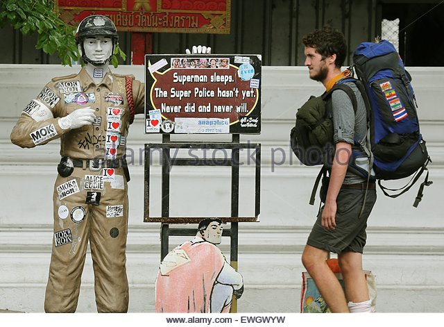epa04814938-a-tourist-walks-past-a-police-themed-statue-in-bangkok-ewgwyw.jpg