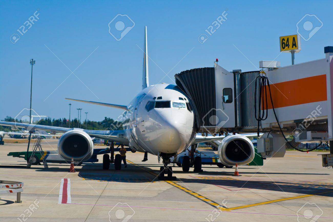 3448364-Plane-parked-at-the-gate-being-served-before-departure--Stock-Photo.jpg