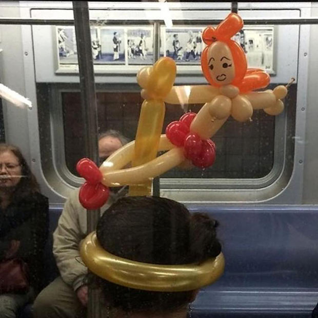 man-subway-pole-dancer-balloon-animals-head-hat.jpg
